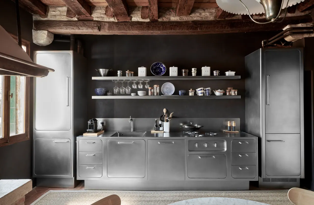 Cucina Abimis a Venezia con parete antracite e mensole per piatti e bicchieri